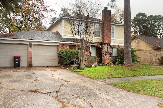 view of front of home with a garage and a front lawn