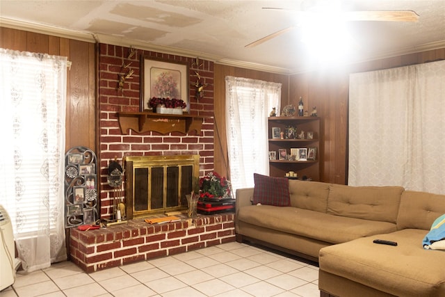 living room with a healthy amount of sunlight, light tile patterned floors, ornamental molding, and a brick fireplace