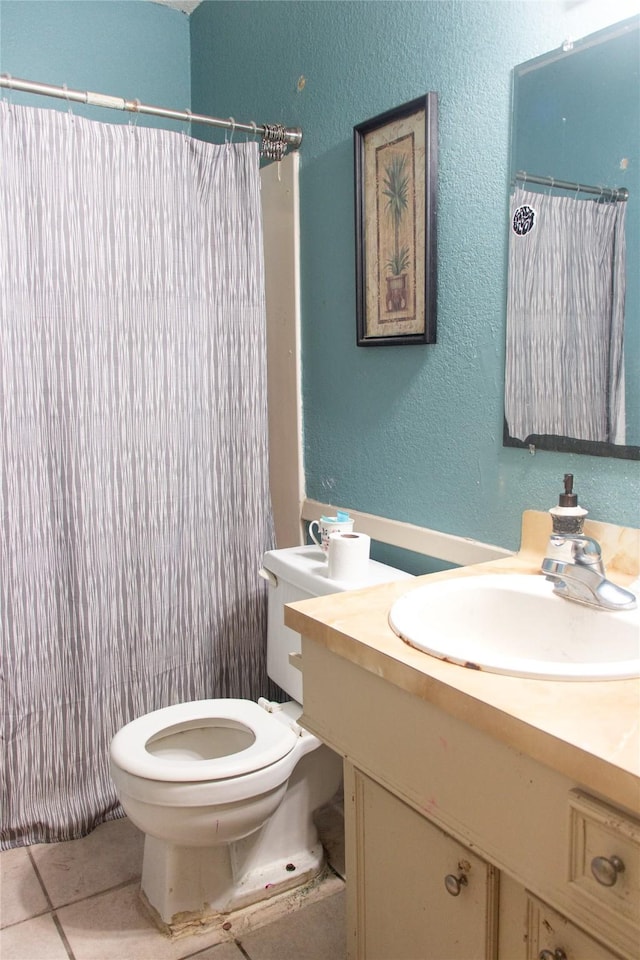 bathroom with tile patterned floors, vanity, curtained shower, and toilet