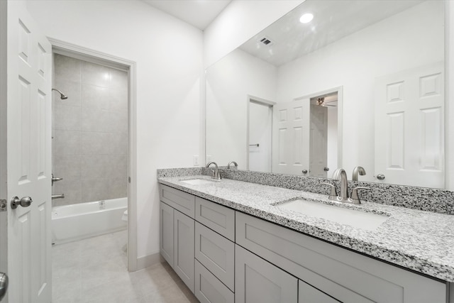 bathroom featuring vanity and tiled shower / bath combo