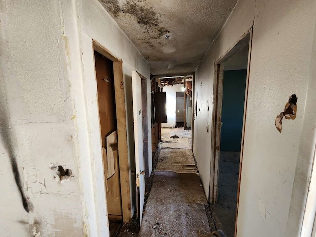 corridor featuring a textured ceiling