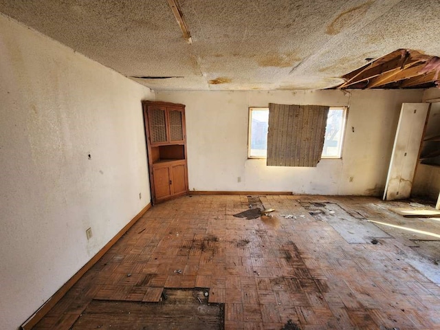 unfurnished room with a textured ceiling