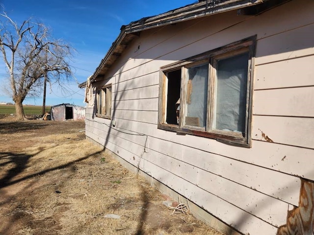 view of home's exterior with a shed