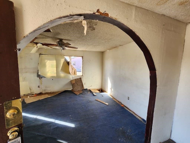 spare room with a textured ceiling and ceiling fan