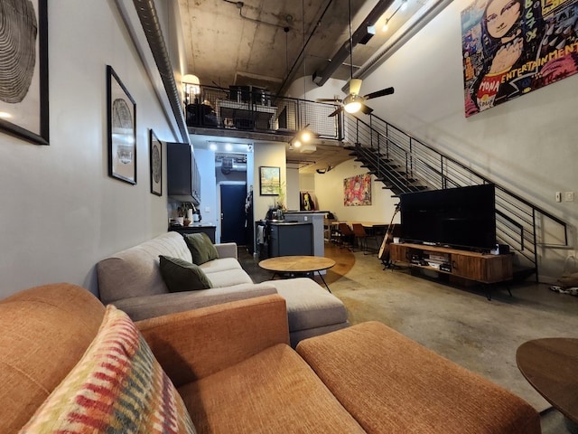 living room with concrete floors and ceiling fan