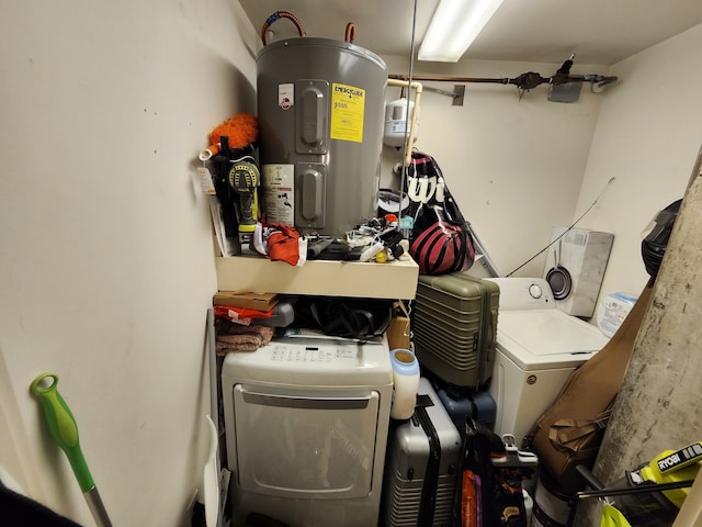 washroom featuring electric water heater and washing machine and dryer