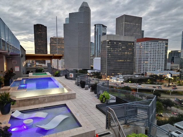 view of pool with an in ground hot tub and a patio area