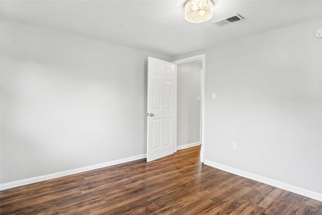 unfurnished room featuring dark wood-type flooring