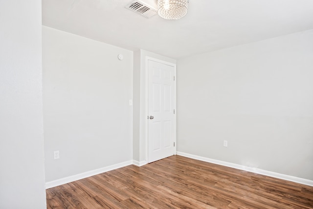 spare room with wood-type flooring