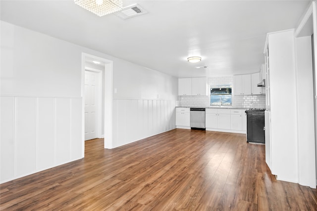 kitchen featuring black range, dishwasher, sink, hardwood / wood-style flooring, and white cabinets