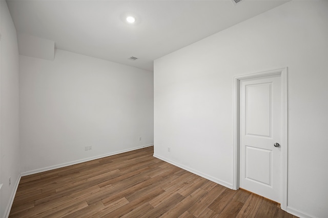 spare room with hardwood / wood-style flooring