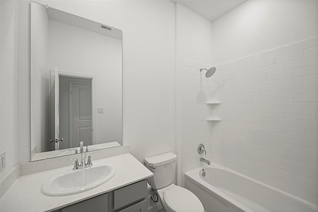 full bathroom featuring tiled shower / bath, vanity, and toilet