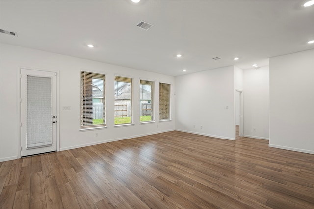 empty room with hardwood / wood-style flooring