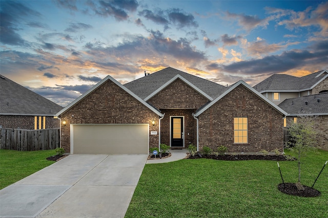 view of front facade featuring a lawn and a garage