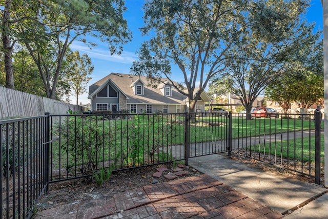 view of gate featuring a yard