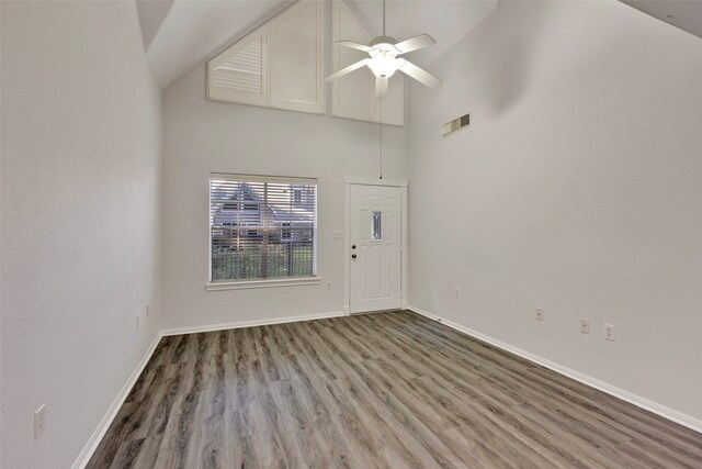 spare room with high vaulted ceiling, hardwood / wood-style flooring, and ceiling fan