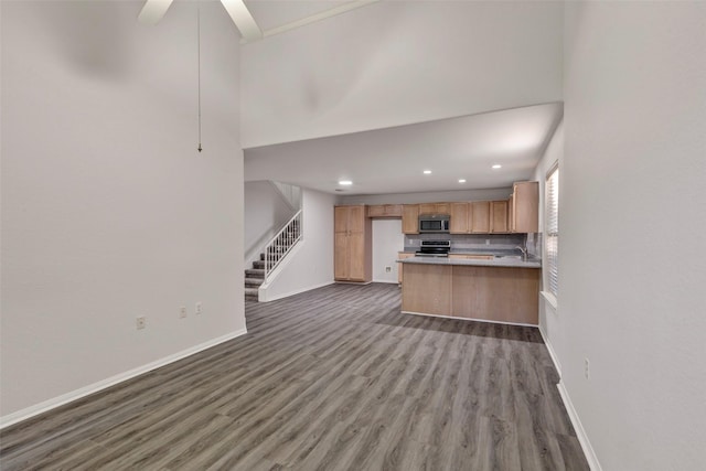 770 Hunt Rd Unit 212, Baytown, TX 77521 - kitchen featuring recessed lighting, decorative backsplash, stainless steel appliances, baseboards, and wood finished floors