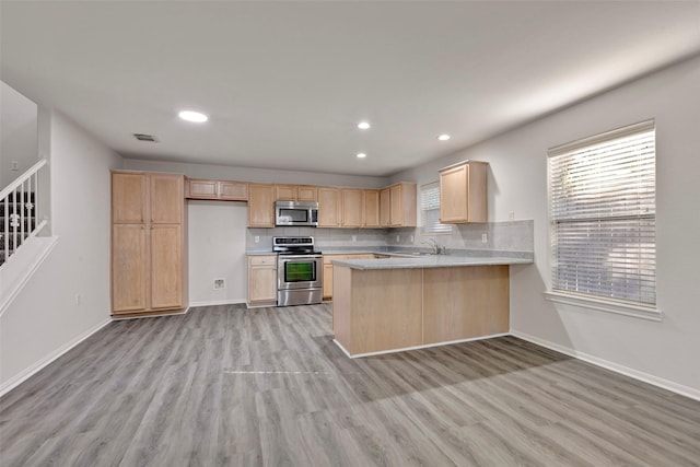 770 Hunt Rd Unit 212, Baytown, TX 77521 - kitchen with appliances with stainless steel finishes, light wood-style floors, light brown cabinets, and light countertops
