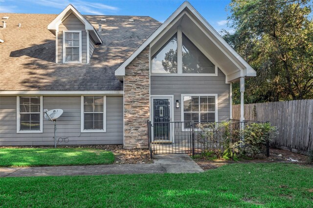 770 Hunt Rd Unit 212, Baytown, TX 77521 - view of front of property with fence, a front yard, and roof with shingles