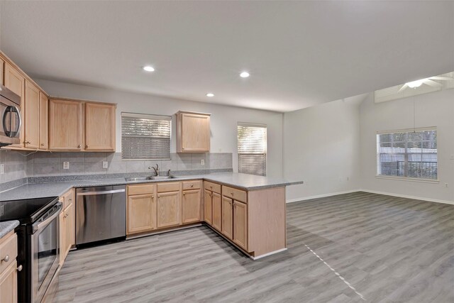770 Hunt Rd Unit 212, Baytown, TX 77521 - kitchen featuring tasteful backsplash, a sink, stainless steel appliances, light brown cabinetry, and a peninsula
