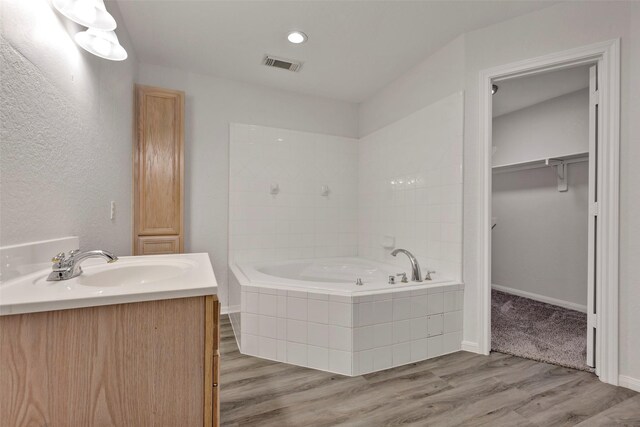 770 Hunt Rd Unit 212, Baytown, TX 77521 - full bath with visible vents, recessed lighting, a bath, wood finished floors, and vanity