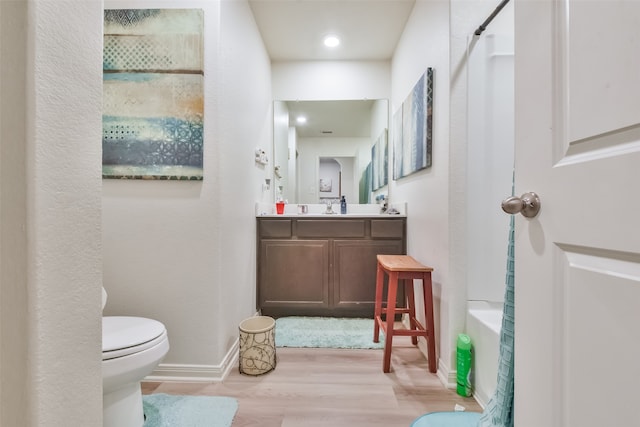 full bathroom featuring hardwood / wood-style floors, separate shower and tub, toilet, and vanity