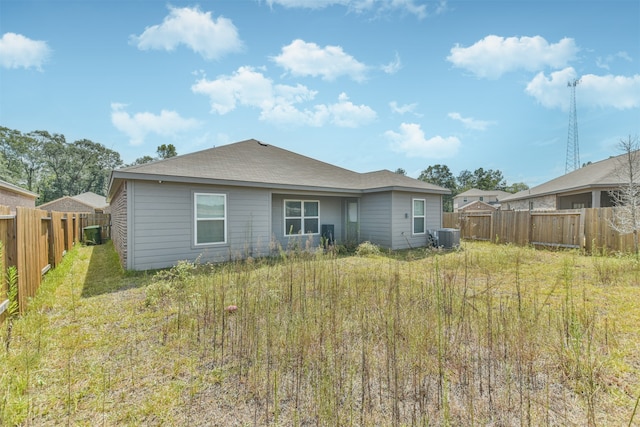 rear view of property featuring central AC