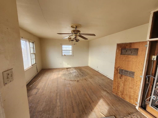 empty room featuring wood-type flooring and ceiling fan