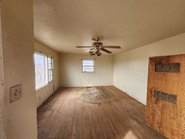 empty room featuring ceiling fan and hardwood / wood-style flooring