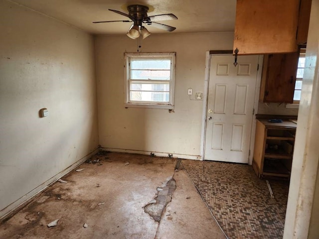 unfurnished dining area featuring ceiling fan