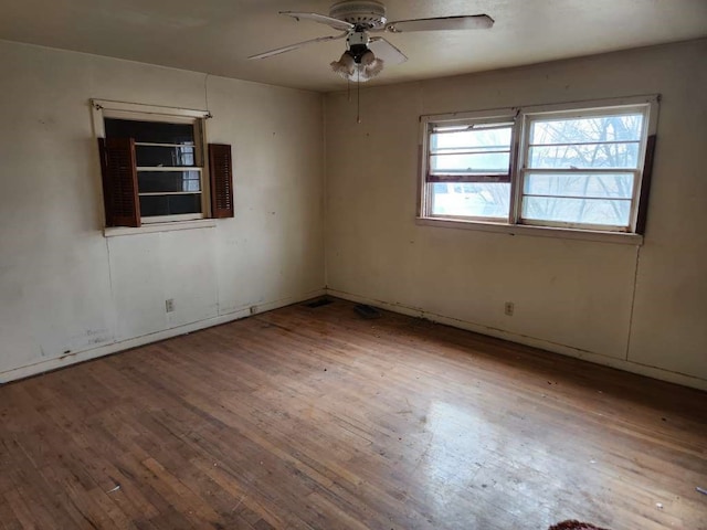 spare room with hardwood / wood-style flooring and ceiling fan