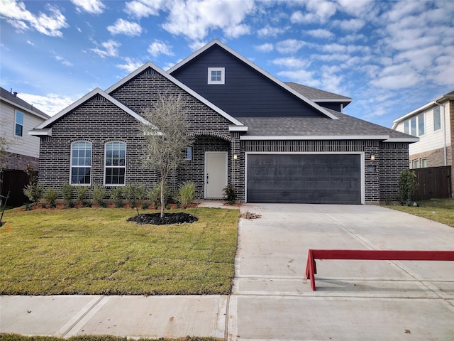 view of front of house with a front yard and a garage