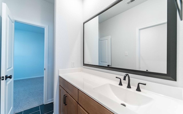 bathroom featuring tile patterned flooring and vanity