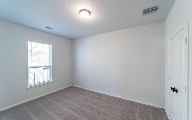 unfurnished room featuring carpet