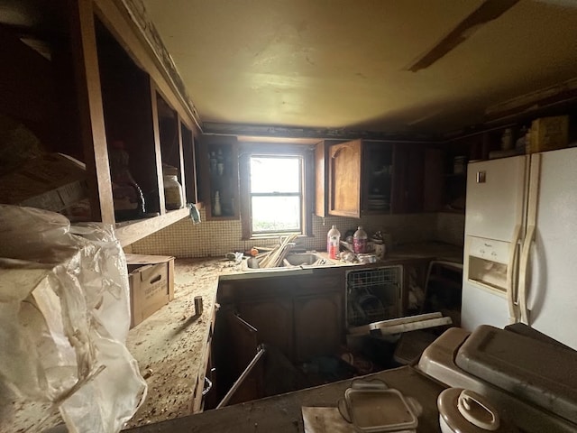 kitchen featuring white refrigerator with ice dispenser and sink