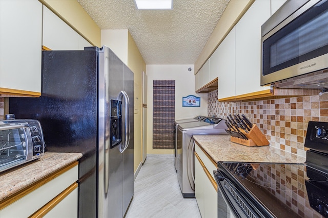 kitchen with appliances with stainless steel finishes, white cabinetry, tasteful backsplash, washer and clothes dryer, and a textured ceiling