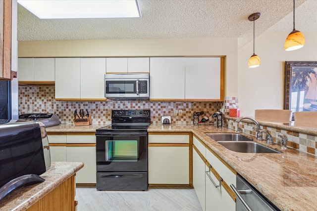 kitchen featuring appliances with stainless steel finishes, white cabinetry, light hardwood / wood-style flooring, and sink