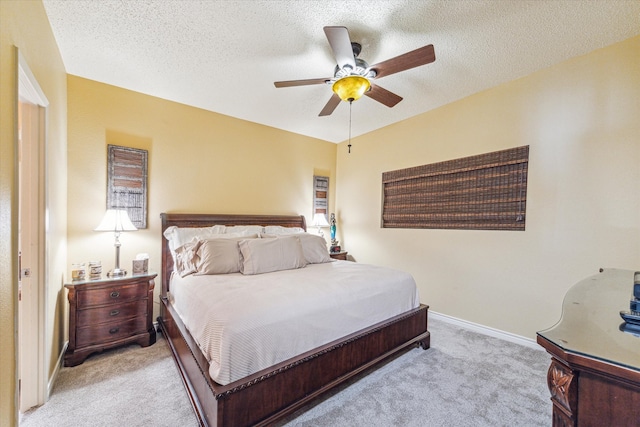 carpeted bedroom with a textured ceiling and ceiling fan