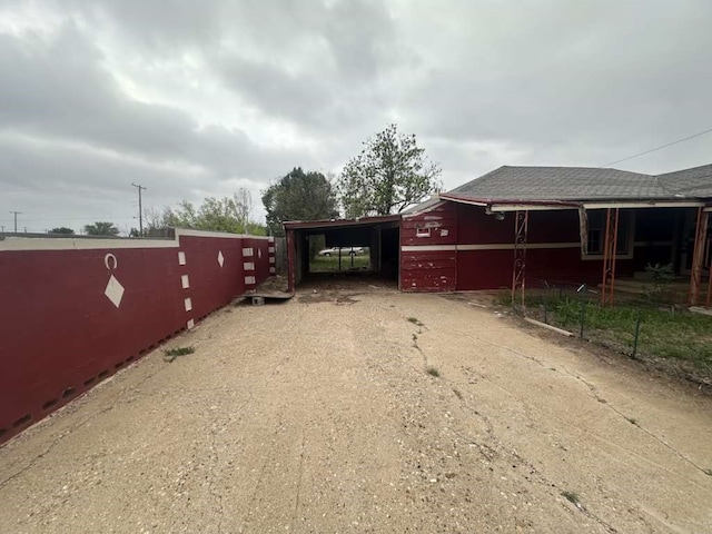 view of gate featuring a carport