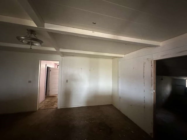 spare room featuring beamed ceiling