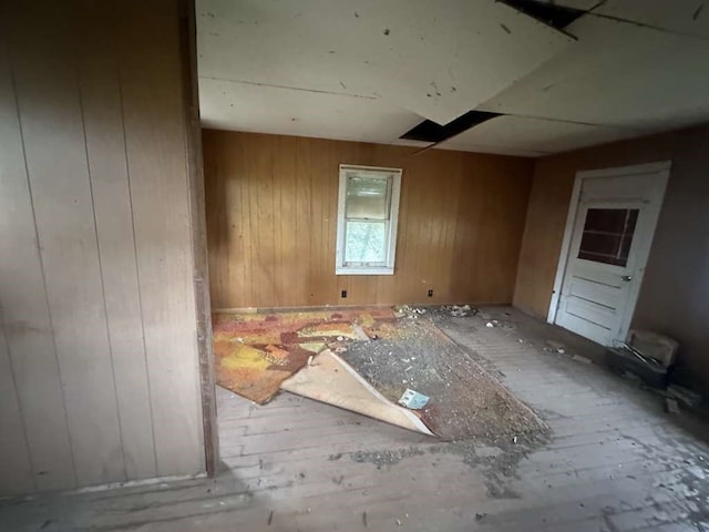 miscellaneous room featuring wood walls