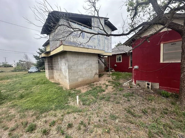 back of property featuring a lawn