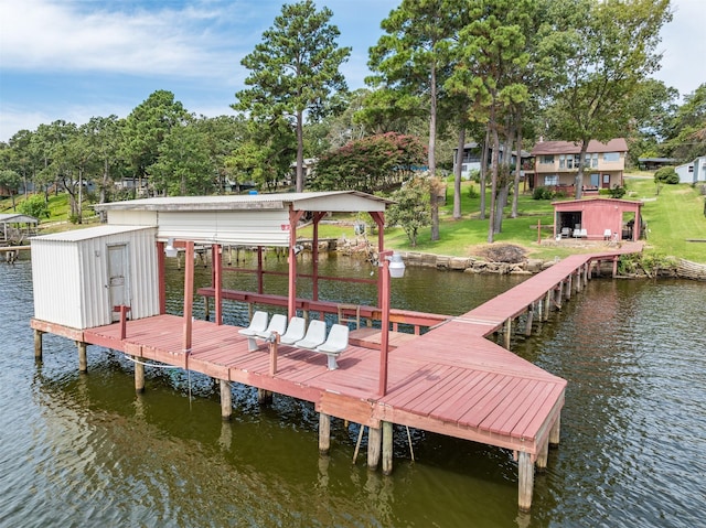 view of dock featuring a yard, a water view, and boat lift