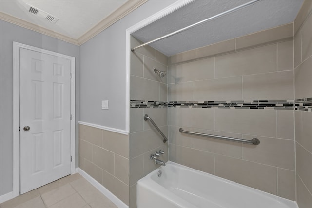 bathroom featuring tile patterned flooring, crown molding, tiled shower / bath, and a textured ceiling