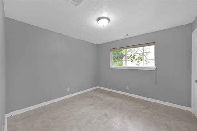 spare room featuring a textured ceiling