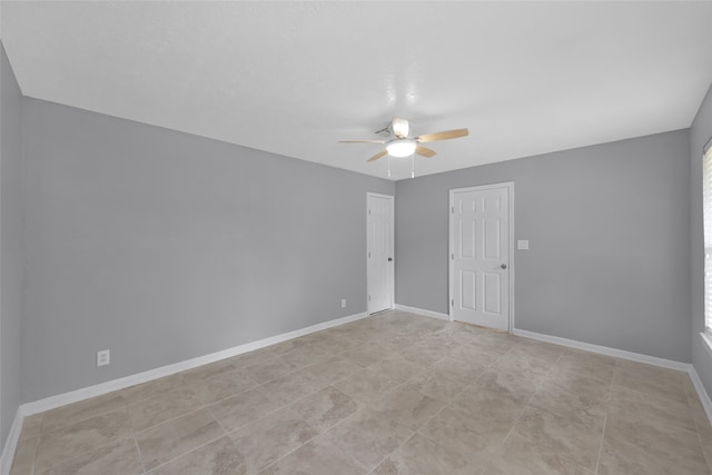 spare room featuring a wealth of natural light and ceiling fan