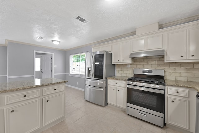 kitchen with ornamental molding, light stone countertops, stainless steel appliances, and white cabinets