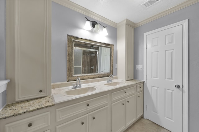 bathroom with crown molding, vanity, and tile patterned floors