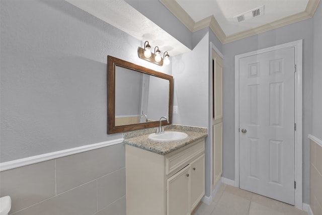 bathroom featuring crown molding, vanity, and tile patterned floors