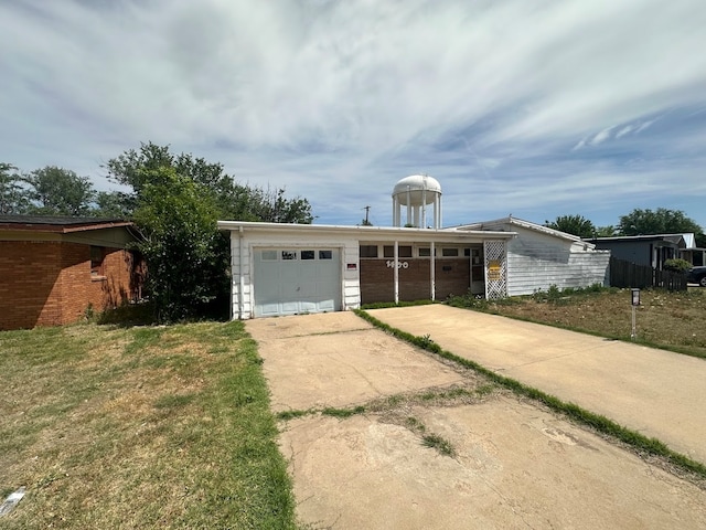 ranch-style home featuring a garage and a front lawn